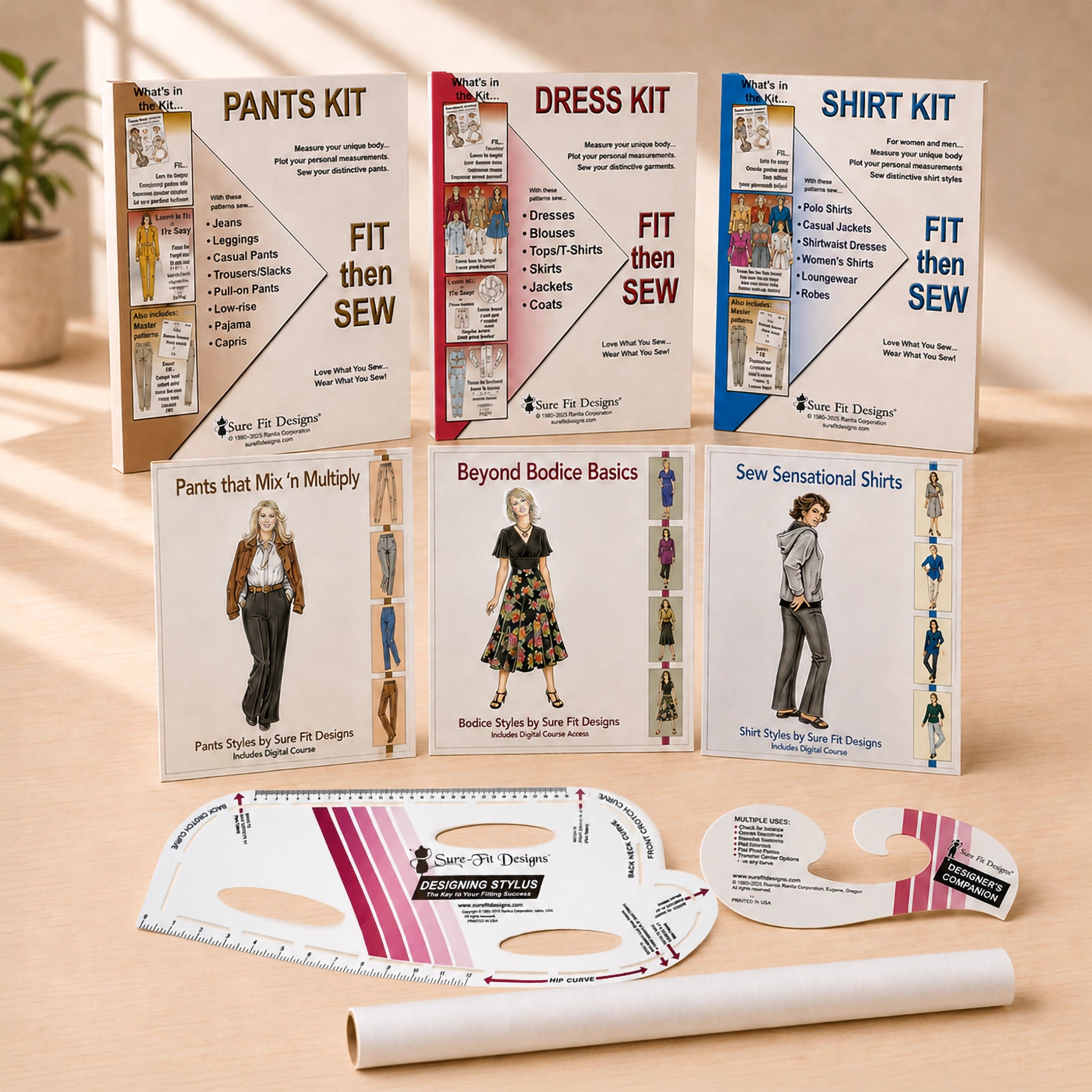 Six sewing kit boxes and two pattern guides arranged on a light wood surface. The boxes are labeled Pants Kit, Dress Kit, and Shirt Kit, with additional titles including Pants That Mix 'n Multiply, Beyond Bodice Basics, and Sew Sensational Shirts.
