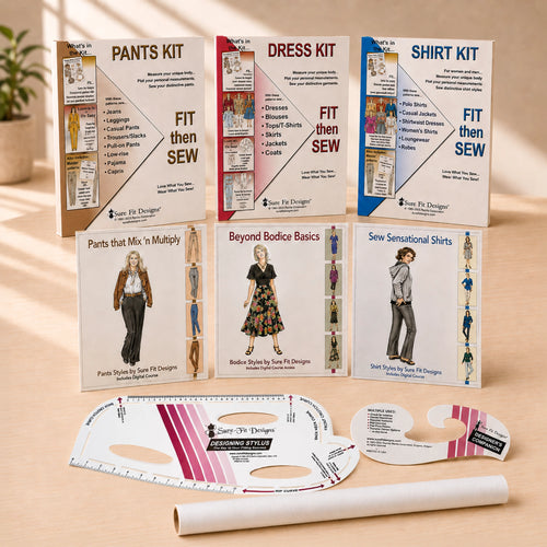 Six sewing kit boxes and two pattern guides arranged on a light wood surface. The boxes are labeled Pants Kit, Dress Kit, and Shirt Kit, with additional titles including Pants That Mix 'n Multiply, Beyond Bodice Basics, and Sew Sensational Shirts.