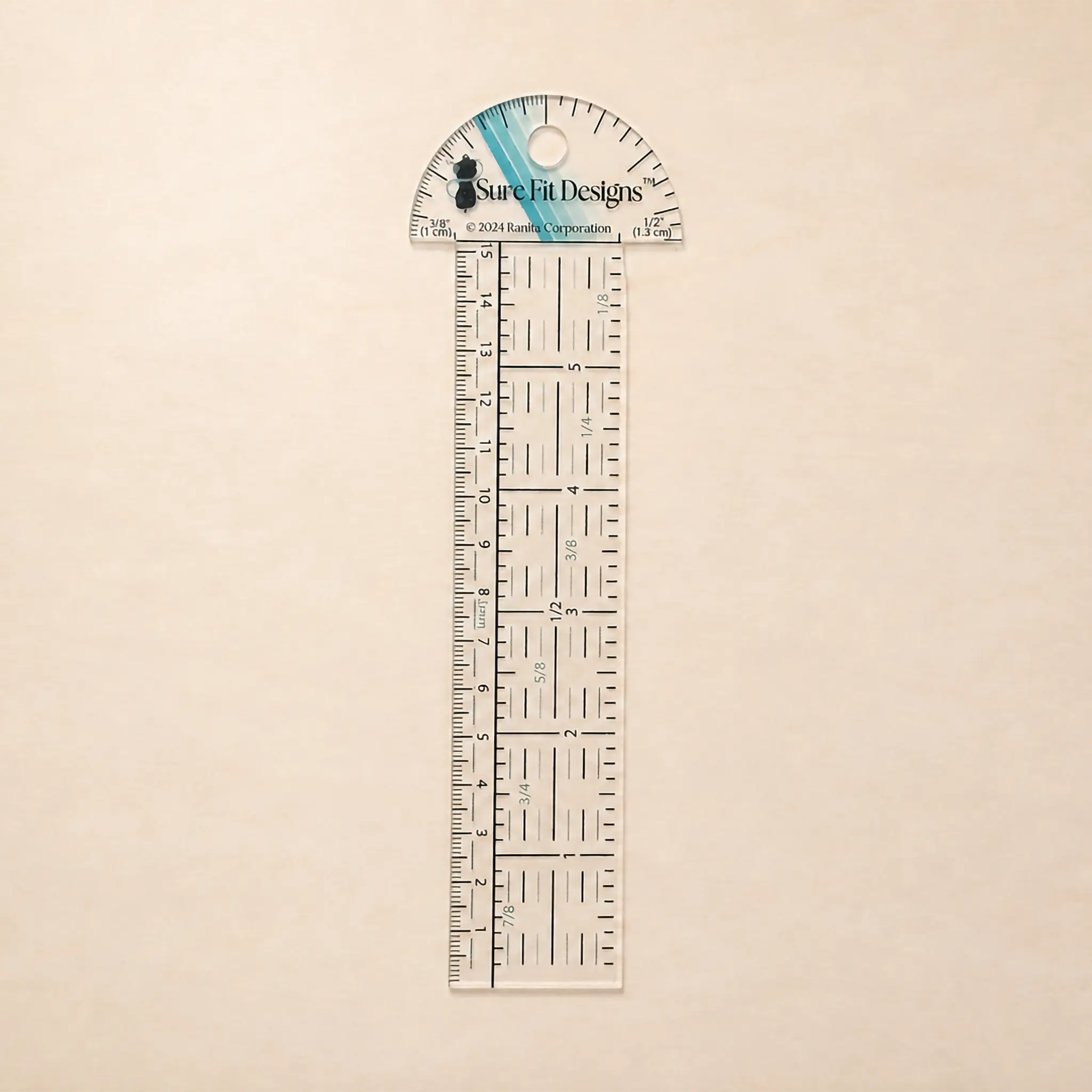 A Sure Fit Designs clear acrylic ruler with a semi-circular protractor top, shown vertically on a light beige textured background.