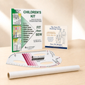 A sewing pattern drafting and fitting kit for children's clothing displayed on a light wood surface, including a printed 'Children's Kit' booklet, a drafting course booklet, a curved ruler, and a roll of tracing paper or vellum.