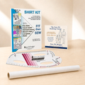 A shirt pattern drafting and fitting kit displayed on a light wood surface, including a large instruction booklet, a drafting template ruler, a roll of tracing vellum, and a smaller course booklet. Visible branding includes Sure Fit Designs.