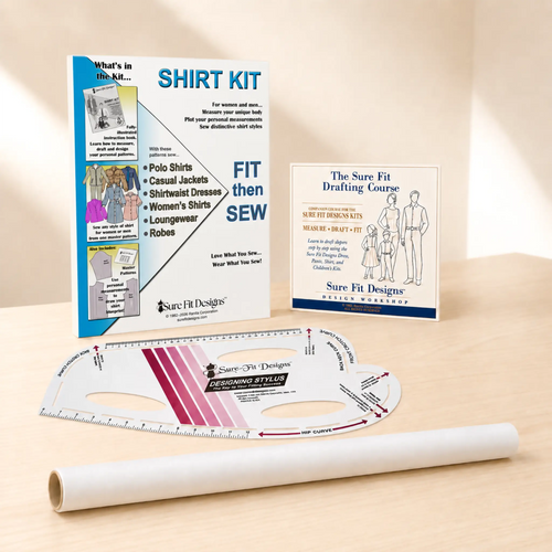 A shirt pattern drafting and fitting kit displayed on a light wood surface, including a large instruction booklet, a drafting template ruler, a roll of tracing vellum, and a smaller course booklet. Visible branding includes Sure Fit Designs.
